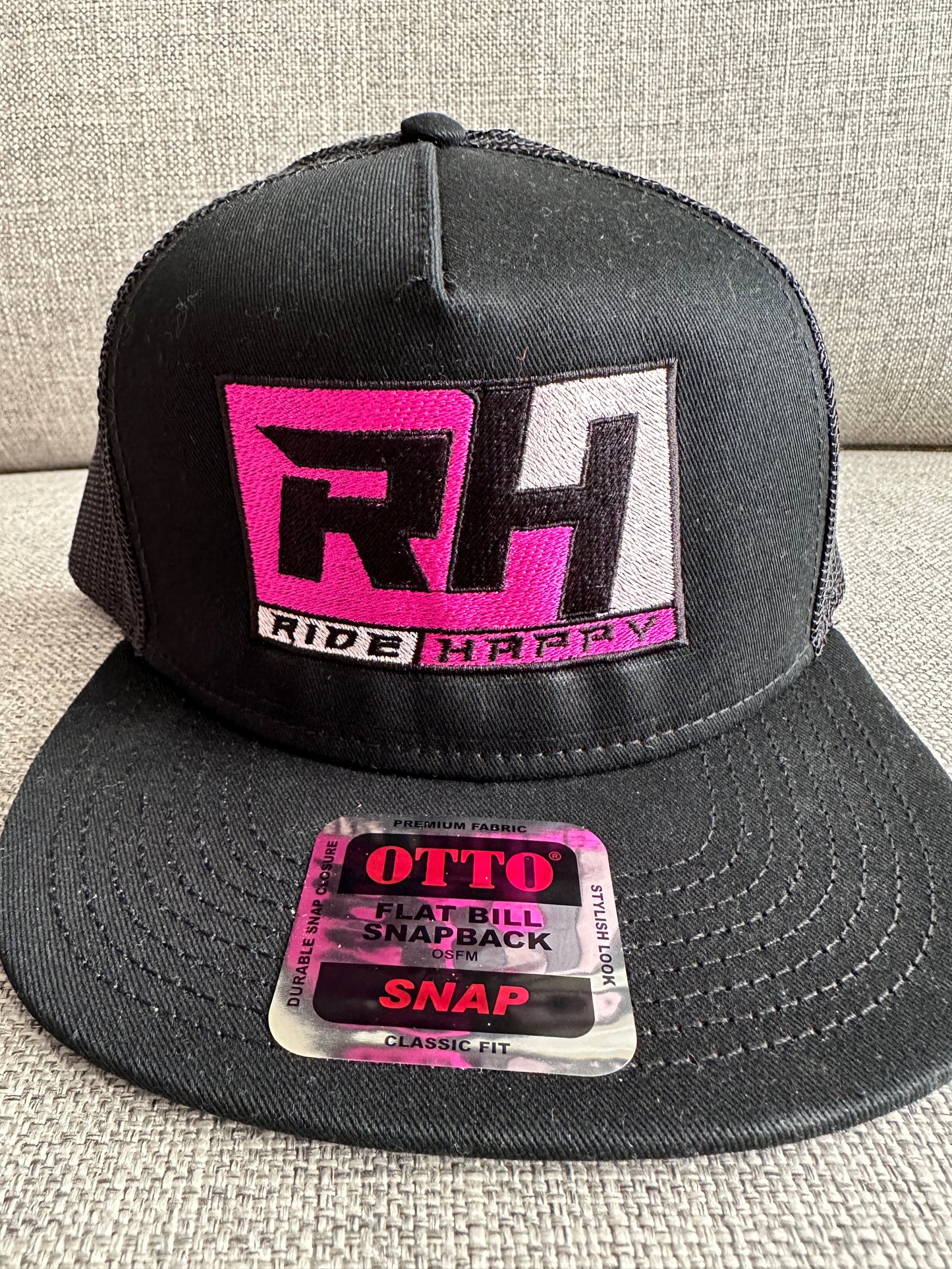 Ride Happy black hat with pink design